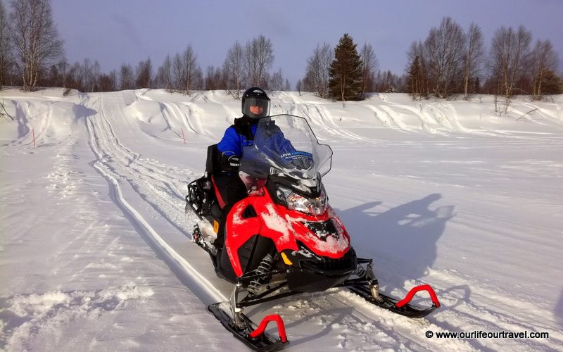 Riding a snowmobile around Levi, Finland